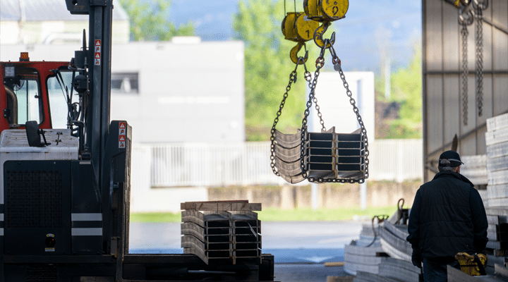 Overhead Cranes and Forklifts work together to move materials inside of a warehouse